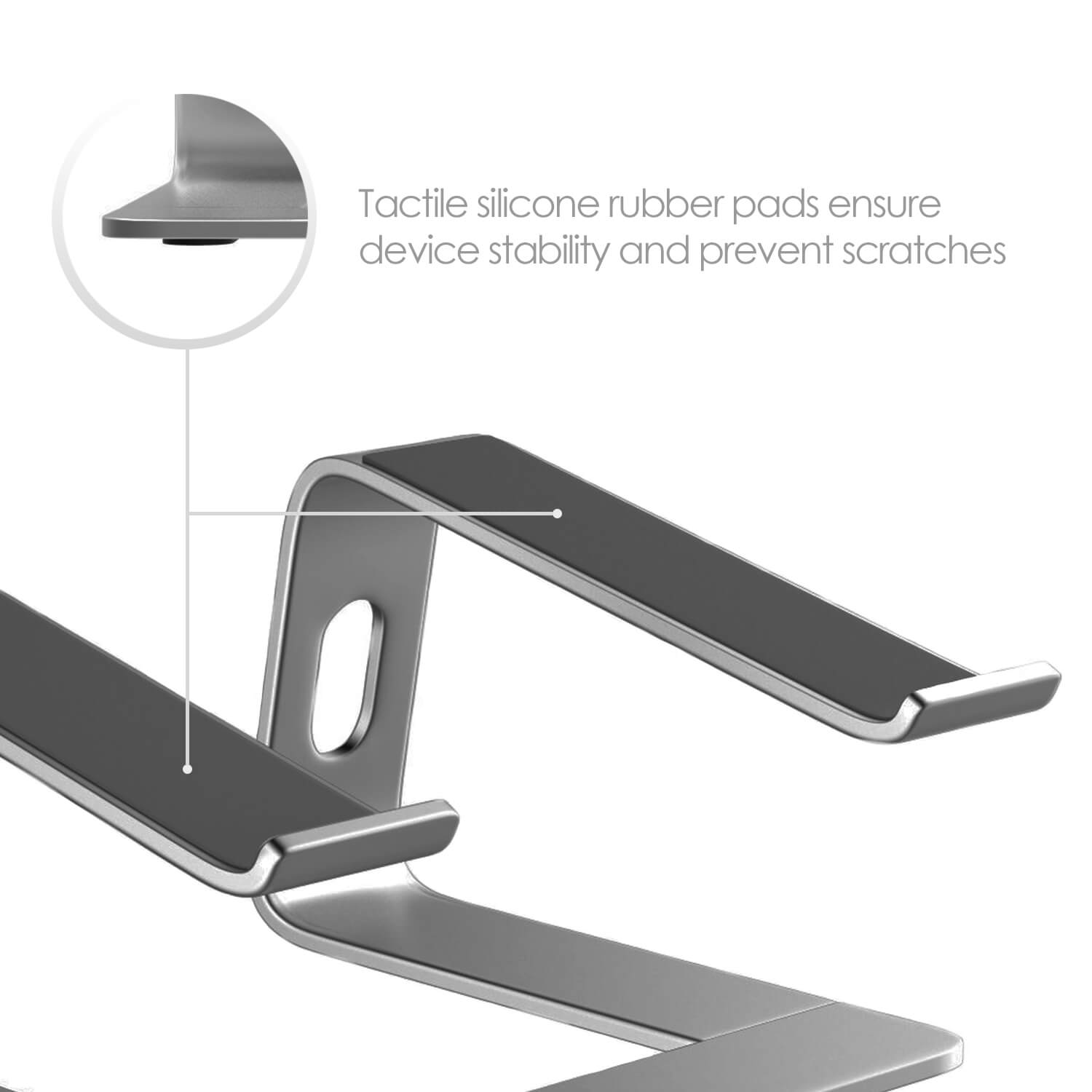 A close up of a precision engineered aluminium laptop stand showing smooth silicone pads on the part which will hold the computer. Text reads "Tactile silicone rubber pads ensure device stability and prevent scratches. "