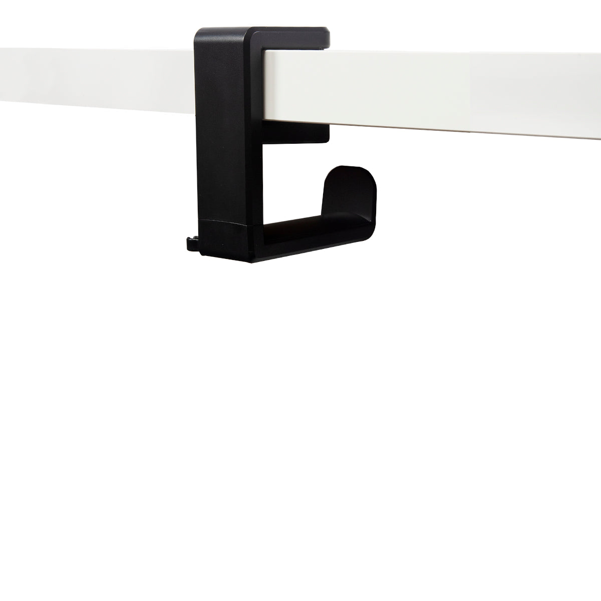 Black plastic under desk headphone hanger clamped to white desk 
